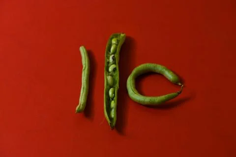String beans seeds closeup on isolated red background Stock Photos