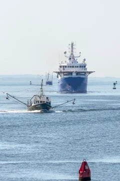 String of boats inbound from hazy Buzzards Bay Stock Photos