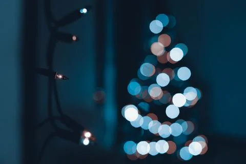 String of Christmas lights hanging on the wall. Stock Photos