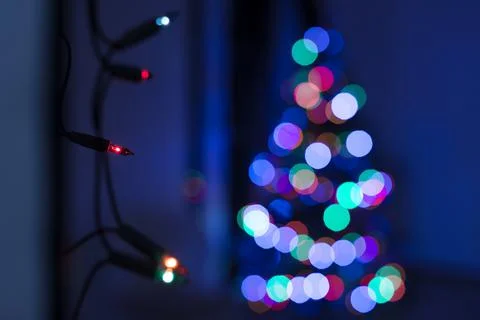 String of Christmas lights hanging on the wall. Stock Photos