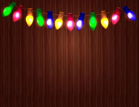 String of Color christmas light bulbs  on wooden background. Illustrazione stock