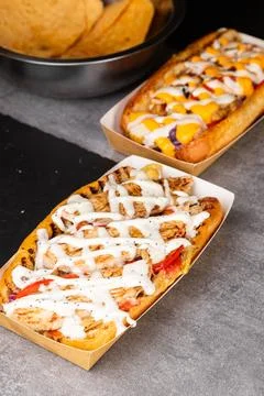 A string of delicious hot dogs from different recipes in paper gondolas Stock Photos