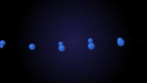 A string of glowing blue decorative festive lights against a dark background Stock Footage 339617372