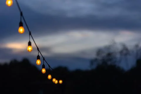 String of glowing edison light bulbs creates festive party vibe Stock Photos