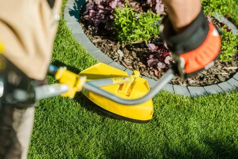 String Grass Trimming Equipment. Taking Care of the Lawn. 库存照片