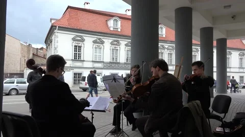 String instrument quartet play on theater square with column. 4K Stock Footage 56249745