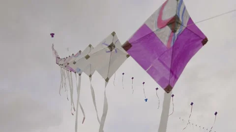 A string of kites floating in the wind Stock Footage 199744918