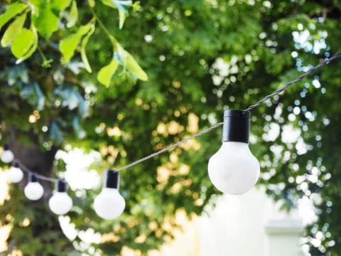 String of light bulbs. Birthday or summer garden party decoration. Modern Fotos Stock