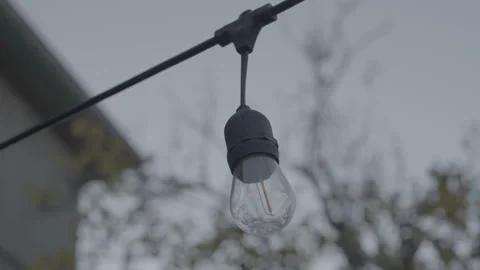 String light with condensation in backyard at sunset Stock Footage 226434550