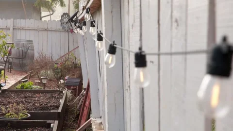 String of lights along white fence Stock Footage 265818515