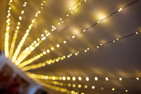 String lights glow softly, creating a warm, out-of-focus pattern Stock Photos