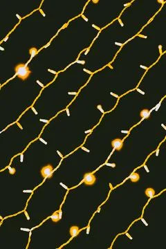 String lights hang on a dark background creating a warm atmosphere suitable.. Stock Photos