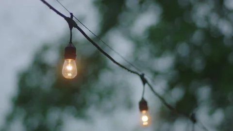 String lights hang outside with an close-up view Stock Footage 251225788