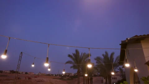 A string of lights hanging from a building Stock Footage 246340297