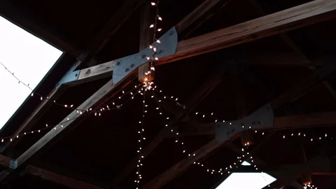 String lights hanging on farm ceiling day time slight parallax Stock Footage 96550612