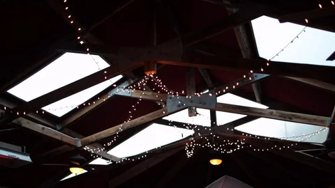 String lights hanging on farm ceiling day time Stock Footage 96550841