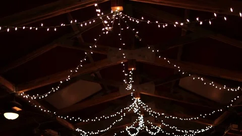 String lights hanging on farm ceiling night Stock Footage 96550981