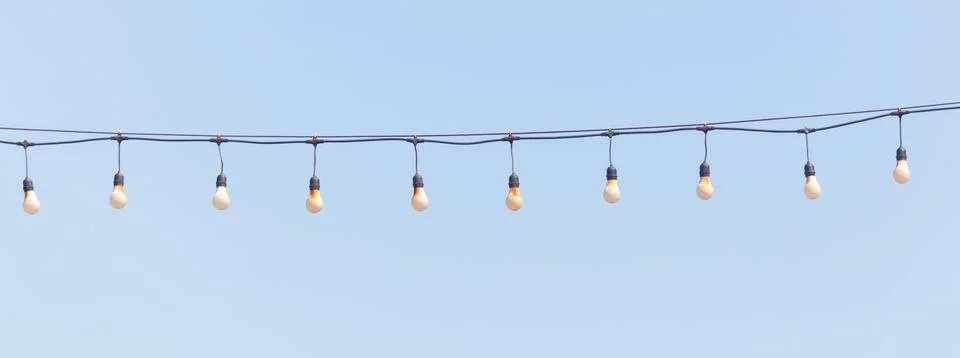 A string of lights hanging from a wire Foto stock