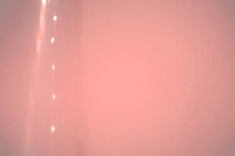 String of lights margin background in soft orange color Stock Photos