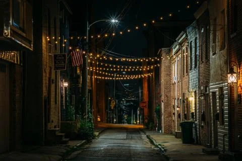 String lights over Chapel Street at night in Butchers Hill, Baltimore, Maryla Stock Photos