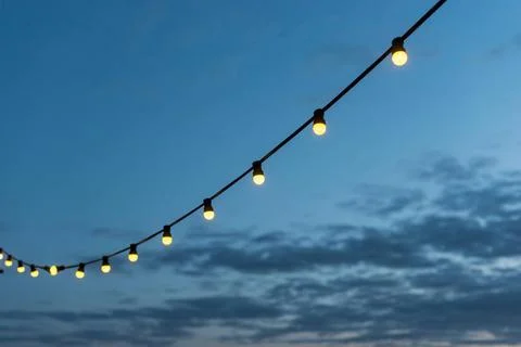 String lights sunset sky. High quality photo string lights sunset sky. Hig... Foto stock