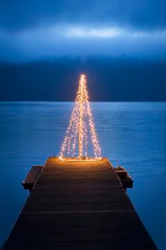 String of lights in tree shape on wooden pier Stock Photos