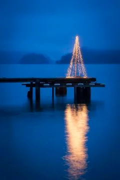 String of lights in tree shape on wooden pier Stock Photos