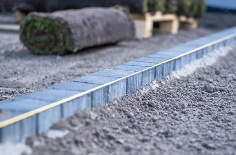 String line marking curved garden edging on prepared soil Stock Photos