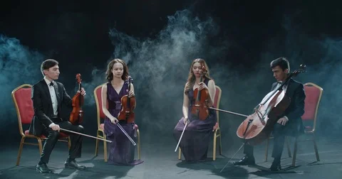 String musicians quartet during the performance of the symphony at the concert Stock Footage