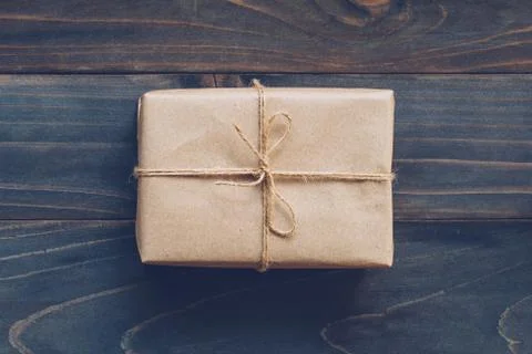 String or twine tied in a bow on kraft paper gift box no wooden table texture Stock Photos