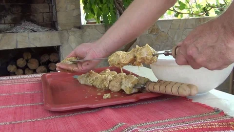 String pieces of meat on a skewer for subsequent frying on the barbecue grill Stock Footage 116051052