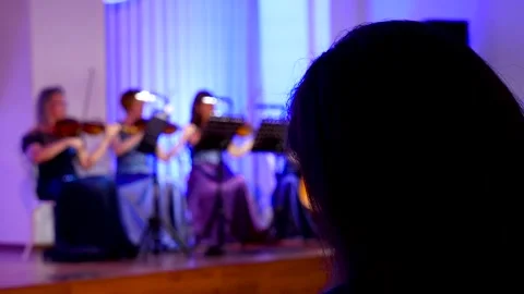 String quartet performing on a blue-lit stage. Video stock 341108976