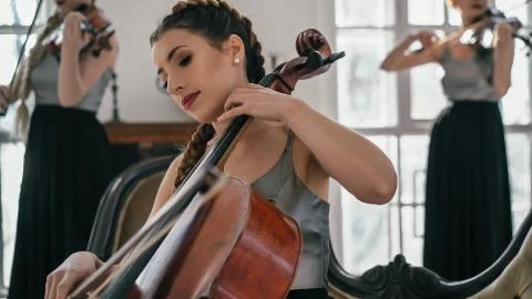 The String Quartet Performs In A Large Room With Big Windows Stock Photos