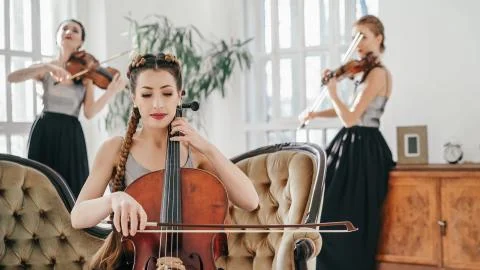 The String Quartet Performs In A Large Room With Big Windows Stock Photos