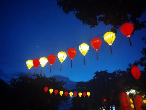 String of Red and Yellow Lanterns Against Twilight Sky – Vietnam Night Stock Photos