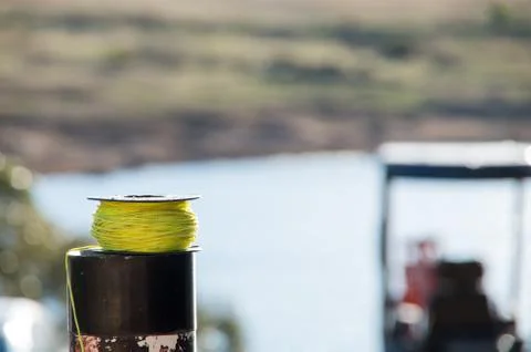 String resting on a post lakeside Stock Photos