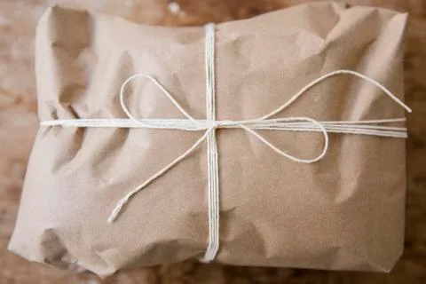 String tied around package wrapped in brown paper Stock Photos
