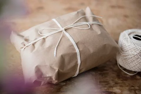 String tied around package wrapped in brown paper Stock Photos
