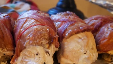 String tied turkey stuffing bacon wrapped parcels on aluminium serving Stock Footage 167868167
