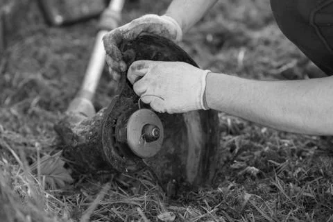 String trimmer cleaning after cutting the grass, workflow, monochrome Foto stock