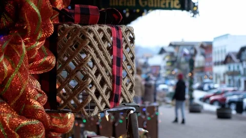 String wrapped present with plaid bow, bow decoration, people shopping and Stock Footage 124824712