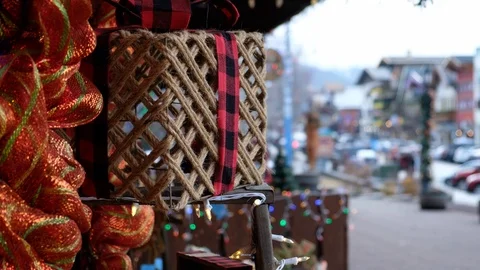 String wrapped present with plaid bow, bow decoration, people shopping and Stock Footage 124824716