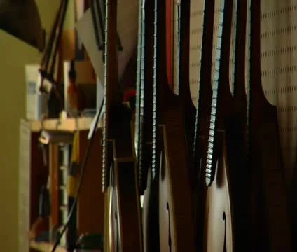 Stringed instruments and worker smoothing wood Stock Footage 21592828