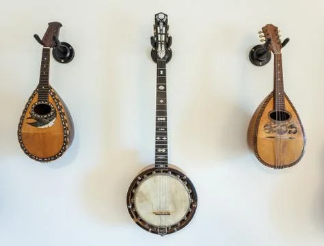 Stringed musical instruments on wall. Stock Photos