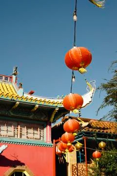 Stringed paper lanterns hang against the sky Stock Photos