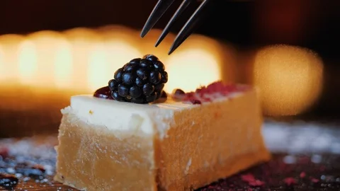 Stringing a blackberry on a cake with a fork Stock Footage 106308654