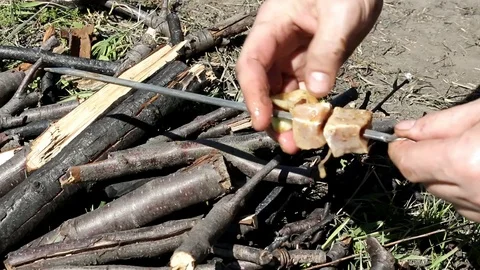 Stringing together pieces of meat on a skewer Stock Footage 90868330