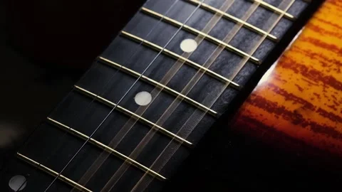 The strings of an acoustic guitar vibrate while playing. Slow motion. Stock Footage 204011071