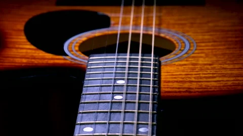 The strings of an acoustic guitar vibrate while playing. Slow motion. Stock Footage 204011072