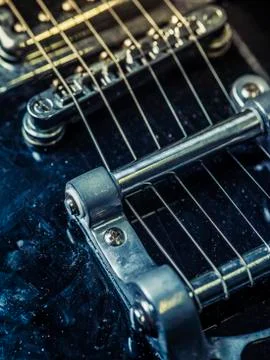 Strings and bridge of an old electric guitar Foto stock